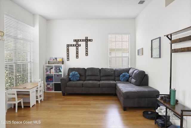 living room with light wood-type flooring and visible vents