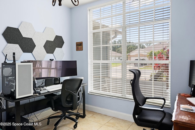 office space with baseboards and tile patterned floors