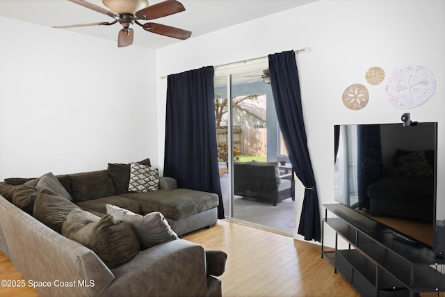 living area with a ceiling fan and wood finished floors
