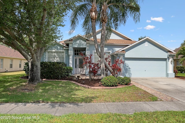 view of front of house featuring a garage, stucco siding, concrete driveway, and a front yard