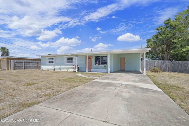 1380 Fiddler Ave, Merritt Island, FL 32952 - ranch-style house featuring fence, concrete driveway, and a front lawn