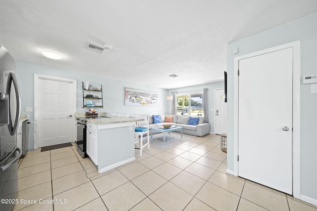 1380 Fiddler Ave, Merritt Island, FL 32952 - kitchen featuring visible vents, open floor plan, appliances with stainless steel finishes, and light tile patterned floors