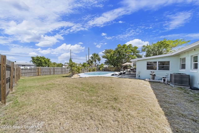 1380 Fiddler Ave, Merritt Island, FL 32952 - view of yard with a patio, central AC unit, a fenced backyard, and a fenced in pool