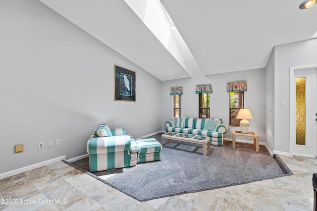 living room with baseboards and vaulted ceiling