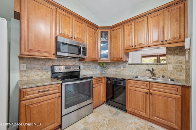 kitchen with stainless steel appliances, brown cabinets, and a sink