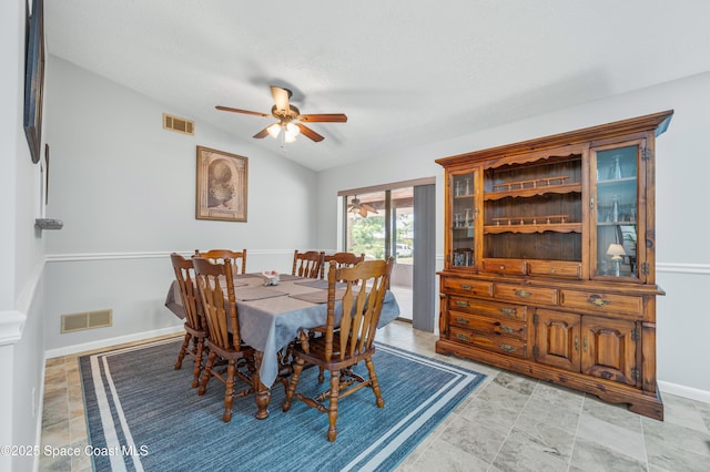 dining room with ceiling fan, baseboards, a textured ceiling, and lofted ceiling