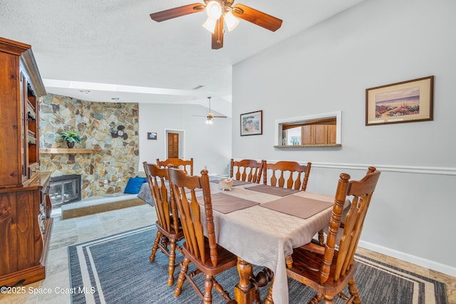 dining room with a ceiling fan, vaulted ceiling, and baseboards