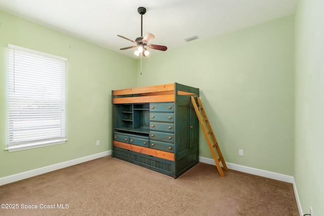 5635 N Tropical Trl, Merritt Island, FL 32953 - unfurnished bedroom featuring baseboards, visible vents, ceiling fan, and carpet