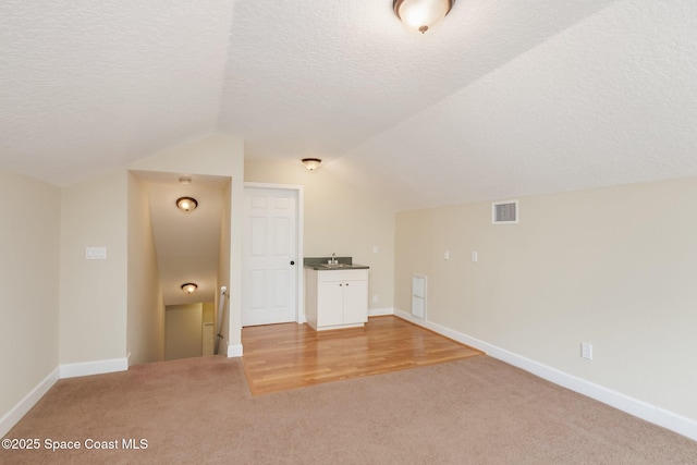 5635 N Tropical Trl, Merritt Island, FL 32953 - bonus room with light colored carpet, baseboards, visible vents, and lofted ceiling