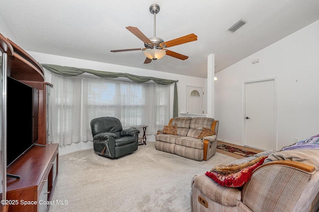 carpeted living room featuring visible vents, ceiling fan, and vaulted ceiling
