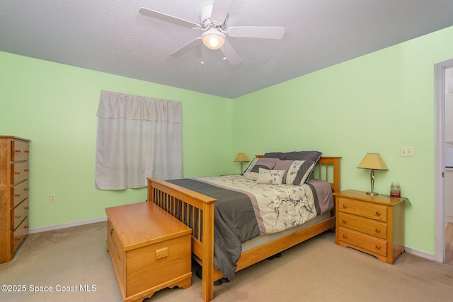 bedroom featuring baseboards, ceiling fan, and light carpet