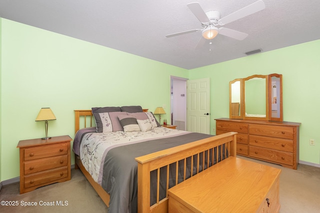 bedroom featuring baseboards, light carpet, a ceiling fan, and visible vents