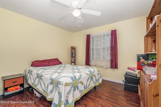 bedroom featuring baseboards, ceiling fan, and wood finished floors
