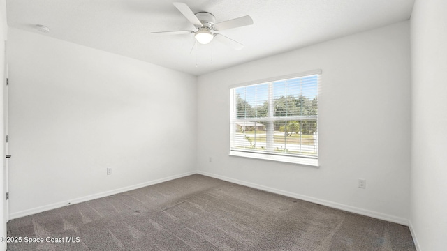 6878 Hartford Rd, Cocoa, FL 32927 - carpeted spare room with baseboards, ceiling fan, and a smoke detector