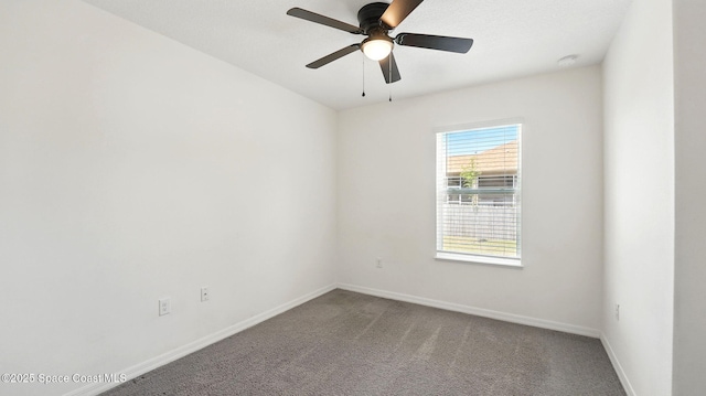 6878 Hartford Rd, Cocoa, FL 32927 - carpeted empty room with baseboards, a ceiling fan, and a smoke detector
