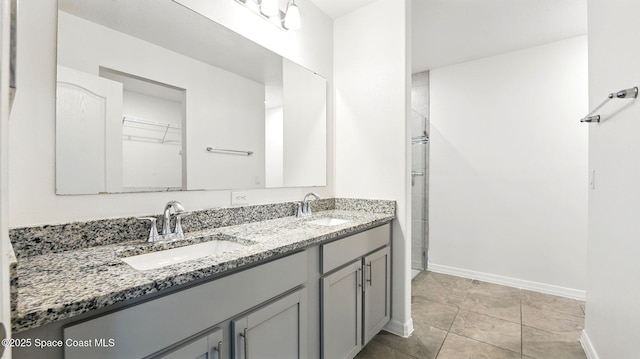 6878 Hartford Rd, Cocoa, FL 32927 - bathroom featuring baseboards, double vanity, and an enclosed shower