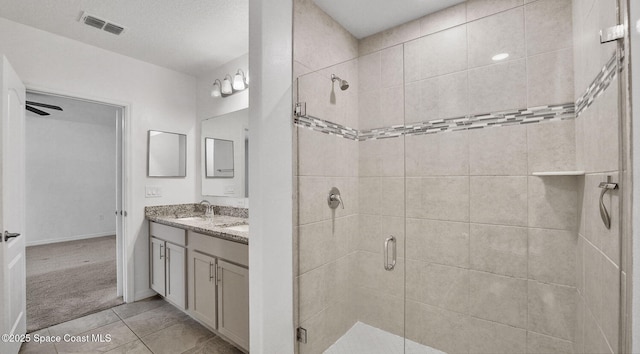 6878 Hartford Rd, Cocoa, FL 32927 - full bath with a stall shower, double vanity, tile patterned flooring, and baseboards
