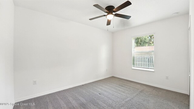 6878 Hartford Rd, Cocoa, FL 32927 - spare room featuring carpet flooring, baseboards, a ceiling fan, and a smoke detector