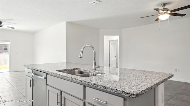 6878 Hartford Rd, Cocoa, FL 32927 - kitchen featuring ceiling fan, a sink, stainless steel dishwasher, a kitchen island with sink, and light tile patterned flooring