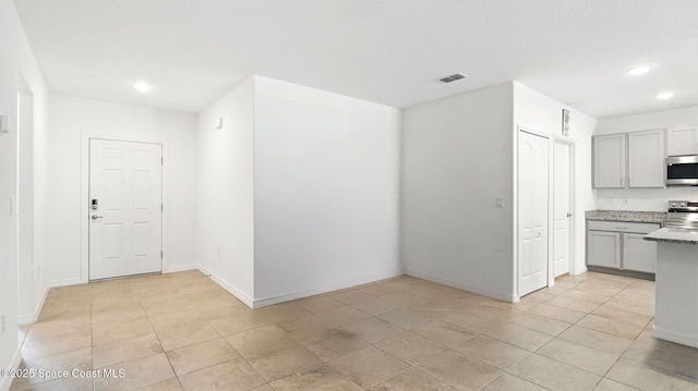 6878 Hartford Rd, Cocoa, FL 32927 - kitchen featuring stainless steel appliances, recessed lighting, light tile patterned flooring, baseboards, and gray cabinets