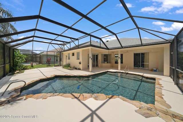 outdoor pool featuring a patio, a ceiling fan, and glass enclosure