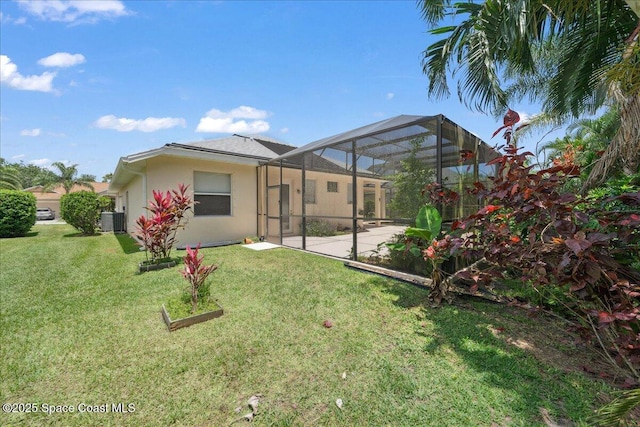 1019 Worthington Spring Dr, Melbourne, FL 32940 - rear view of house with a patio area, stucco siding, central AC, and a lawn