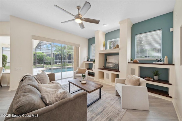 1019 Worthington Spring Dr, Melbourne, FL 32940 - living room featuring a ceiling fan, wood finished floors, and baseboards