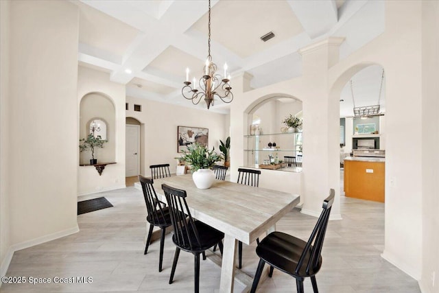 1019 Worthington Spring Dr, Melbourne, FL 32940 - dining space featuring arched walkways, a chandelier, beam ceiling, coffered ceiling, and baseboards