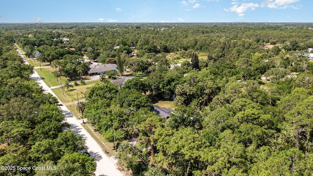 drone / aerial view featuring a wooded view