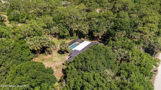 drone / aerial view featuring a forest view
