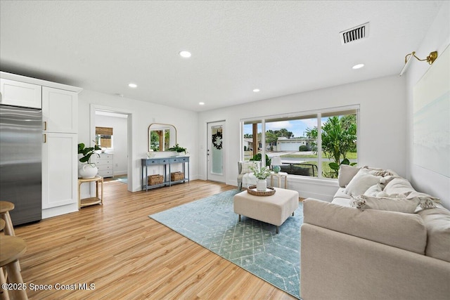2059 Barracuda Ave, Melbourne Beach, FL 32951 - living room with recessed lighting, visible vents, and light wood-style flooring