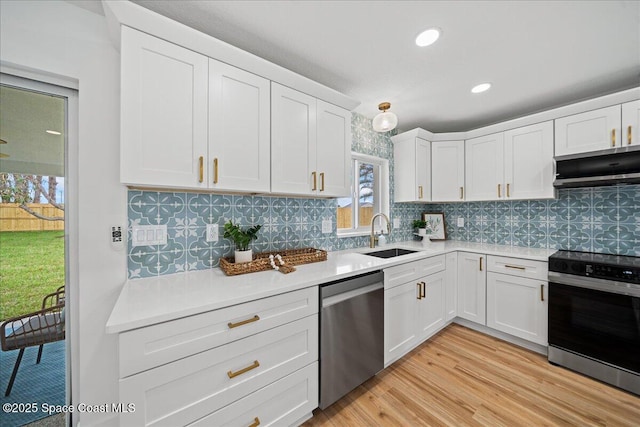 2059 Barracuda Ave, Melbourne Beach, FL 32951 - kitchen featuring exhaust hood, a sink, light countertops, range with electric cooktop, and stainless steel dishwasher