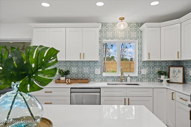 2059 Barracuda Ave, Melbourne Beach, FL 32951 - kitchen featuring a sink, light countertops, white cabinetry, decorative backsplash, and stainless steel dishwasher