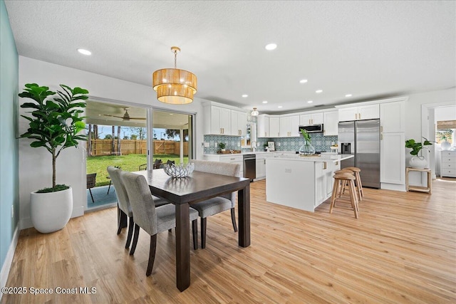 2059 Barracuda Ave, Melbourne Beach, FL 32951 - dining room featuring recessed lighting and light wood-style flooring