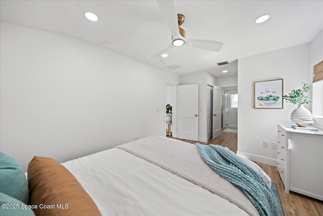 2059 Barracuda Ave, Melbourne Beach, FL 32951 - bedroom with ensuite bath, recessed lighting, baseboards, wood finished floors, and visible vents