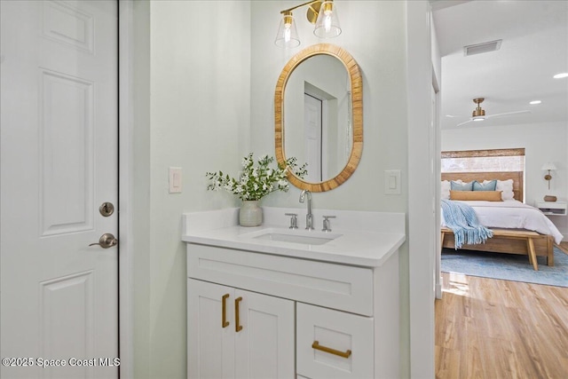 2059 Barracuda Ave, Melbourne Beach, FL 32951 - ensuite bathroom featuring vanity, recessed lighting, wood finished floors, ensuite bathroom, and visible vents