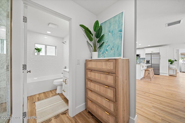 2059 Barracuda Ave, Melbourne Beach, FL 32951 - bathroom with vanity, shower / bathtub combination, decorative backsplash, wood finished floors, and visible vents