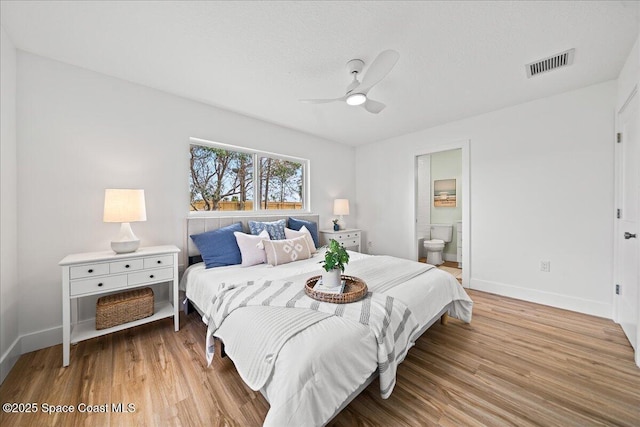 2059 Barracuda Ave, Melbourne Beach, FL 32951 - bedroom with ensuite bath, a ceiling fan, baseboards, wood finished floors, and visible vents
