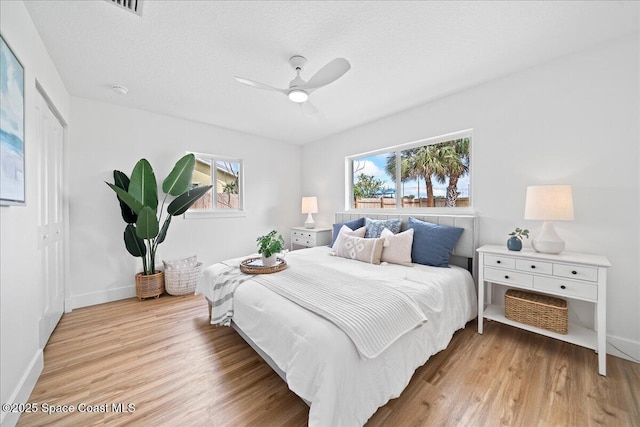 2059 Barracuda Ave, Melbourne Beach, FL 32951 - bedroom featuring baseboards, multiple windows, and light wood-type flooring