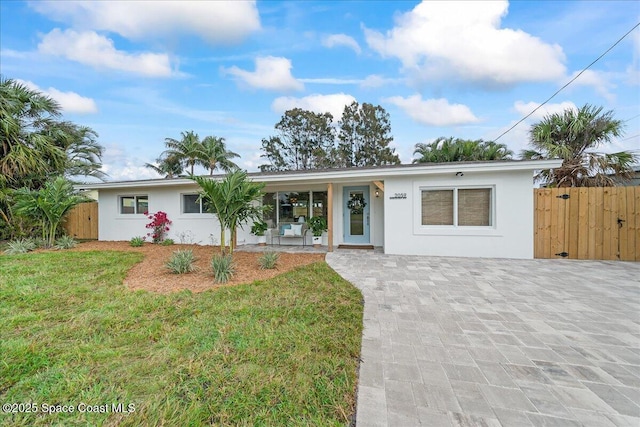 2059 Barracuda Ave, Melbourne Beach, FL 32951 - single story home featuring fence, stucco siding, and a front lawn