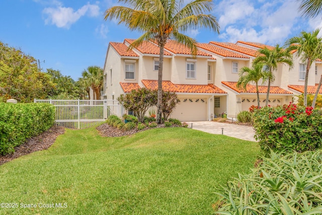 mediterranean / spanish-style home with a tiled roof, an attached garage, driveway, and stucco siding