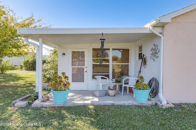 4001 Bayberry Dr, Melbourne, FL 32901 - entrance to property with a lawn, a patio, and stucco siding