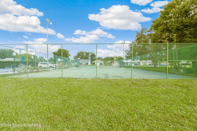 4001 Bayberry Dr, Melbourne, FL 32901 - view of tennis court with fence and a yard