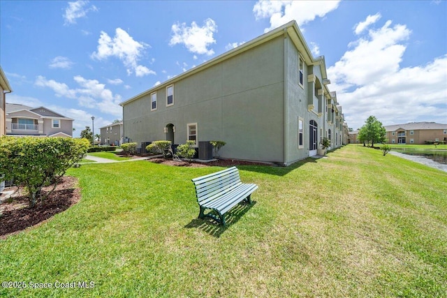 4016 Meander Pl Unit 207, Rockledge, FL 32955 - back of house featuring a yard, a residential view, and stucco siding