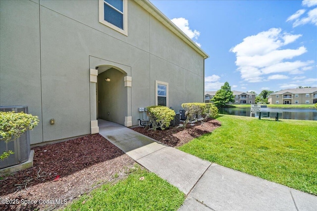 4016 Meander Pl Unit 207, Rockledge, FL 32955 - property entrance featuring a lawn, a water view, stucco siding, and a residential view