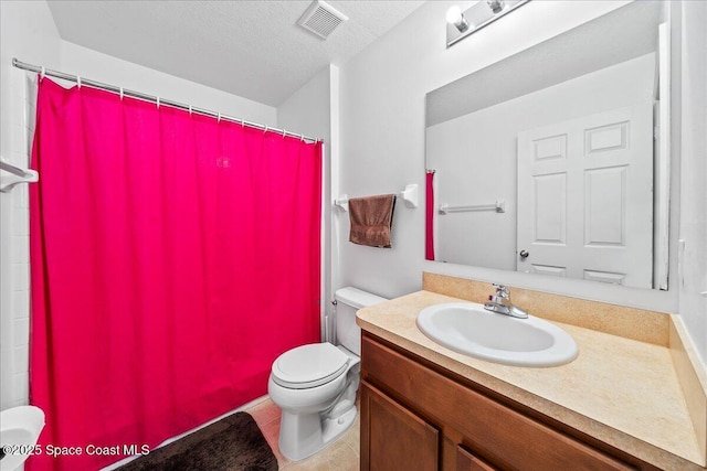 4016 Meander Pl Unit 207, Rockledge, FL 32955 - bathroom with toilet, vanity, curtained shower, tile patterned flooring, and a textured ceiling