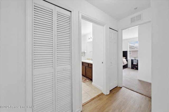 4016 Meander Pl Unit 207, Rockledge, FL 32955 - hallway featuring light wood-style floors and baseboards
