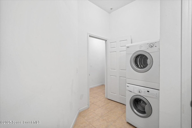 4016 Meander Pl Unit 207, Rockledge, FL 32955 - washroom featuring stacked washer and clothes dryer and baseboards