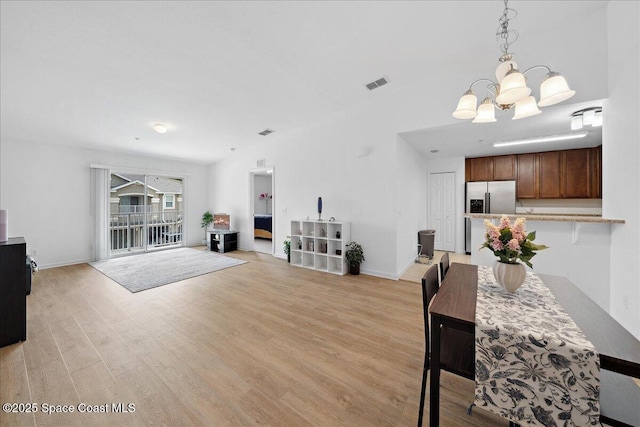 4016 Meander Pl Unit 207, Rockledge, FL 32955 - dining area with a chandelier, light wood-type flooring, and baseboards