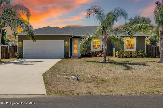 single story home featuring fence, stucco siding, concrete driveway, and a front lawn